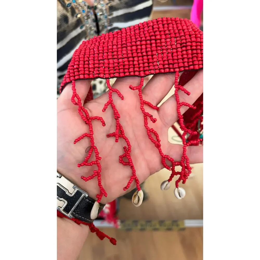 Antica Sartoria elastic belt features red glass seed beads a seashell fringe